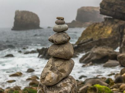 A balanced stack of stones on a tranquil background.