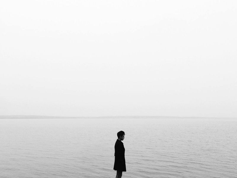 Person peacefully meditating in a minimalist space.